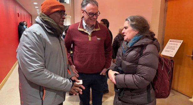 A group of people standing in a room  AI-generated content may be incorrect.