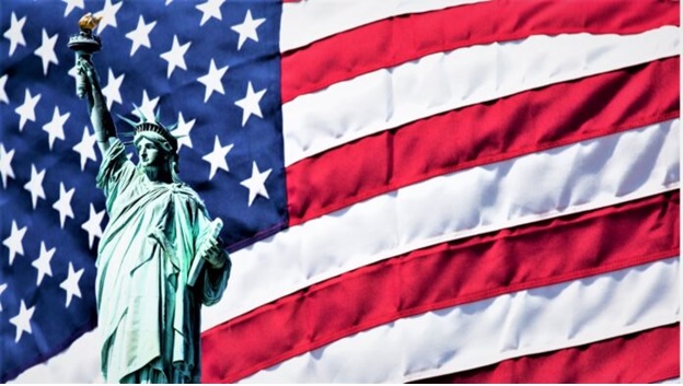 A statue of a person in front of a flag  AI-generated content may be incorrect.