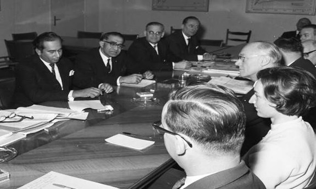 A group of people sitting around a table  AI-generated content may be incorrect.