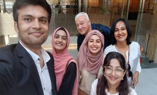 A group of people posing for a photo  AI-generated content may be incorrect.