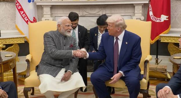 Two men shaking hands in a room  AI-generated content may be incorrect.