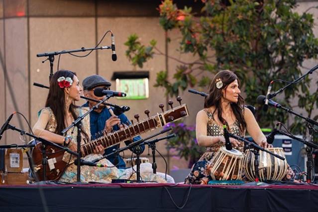 A group of people playing instruments  AI-generated content may be incorrect.